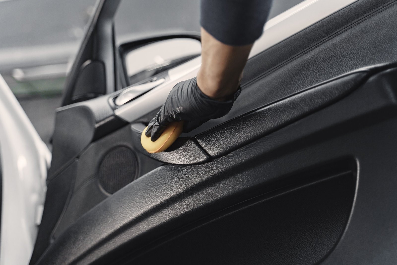 Man polish salon of car in a garage car detailing in kent